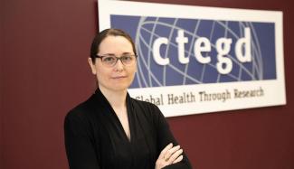 An image of Belen Cassera standing with her arms folded and looking at the camera.