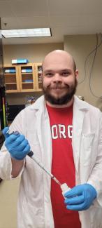 Johnathan Mayfield in a lab coat